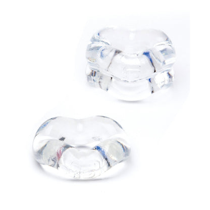 Two transparent, glass-like heart-shaped objects with smooth surfaces rest on a white background. They appear small yet reflective, showcasing their clarity and form—much like the elegant minimalism of the Sport Fucker Revolution Combo Set by Sport Fucker.