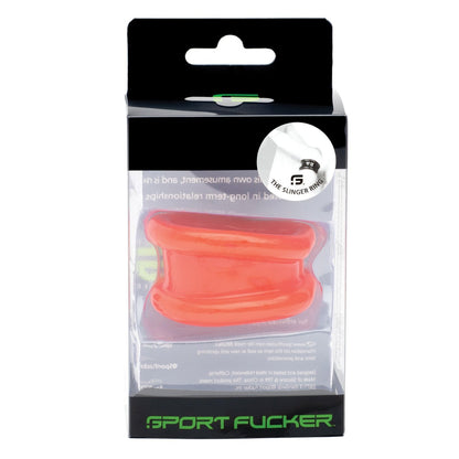 The Sport Fucker Slinger Ring is packaged in a clear plastic box with sleek black and green branding at the base. A small product logo sticker in the top right corner subtly hints at its dual purpose as a ball stretcher or cock ring, showcasing bold innovation.