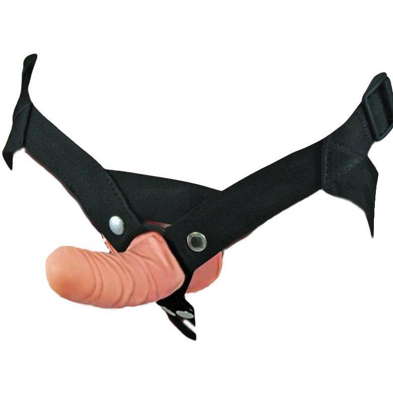 Introducing the Sportsheets Everlaster Harness Stud: a strap-on featuring a realistic flesh-toned dildo, black adjustable straps, and metal snap buttons for secure comfort and confidence.
