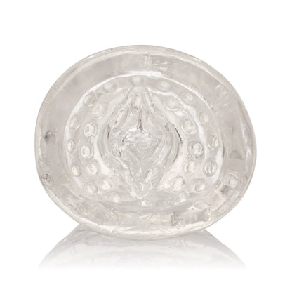 A close-up of a transparent, circular silicone object by California Exotic Novelties features a textured, raised pattern. The sleeve has reflective qualities, creating subtle highlights and shadows reminiscent of the Sue Johanson Head Honcho design.