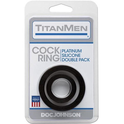 The TitanMen Platinum Silicone Cock Ring Pack of 2 features a mostly white and blue package displaying two black silicone rings through clear plastic. A small American flag icon on the bottom proudly reads Built in America, emphasizing its body-safe silicone craftsmanship.